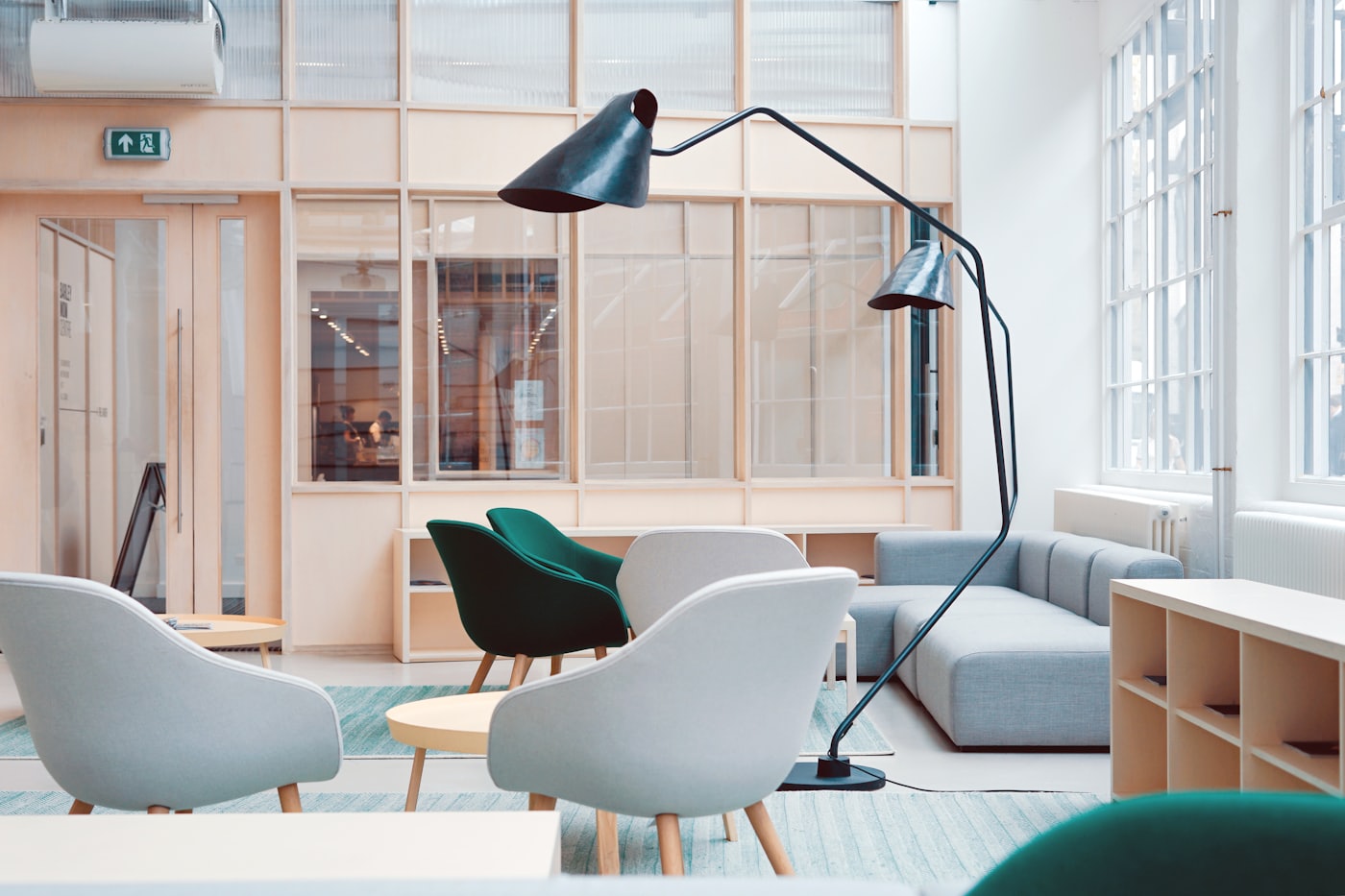 A bright, contemporary lounge with designer seating and lighting